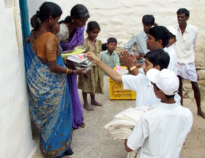 Grama Seva: The villagers receiving prasadam and clothes from the students